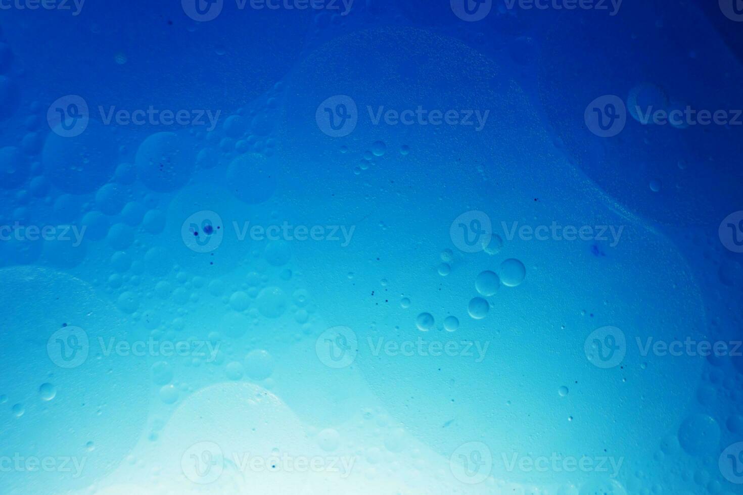 Oil bubbles close up. circles of water macro. abstract light blue background photo
