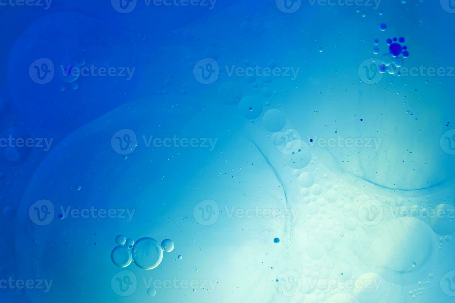 Oil bubbles close up. circles of water macro. abstract light blue background photo