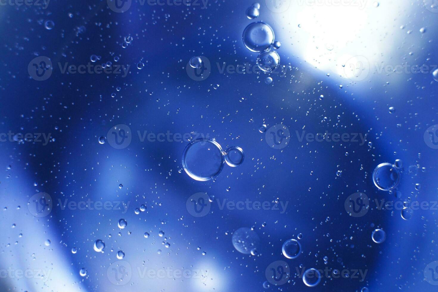 Oil bubbles close up. circles of water macro. abstract light blue background photo