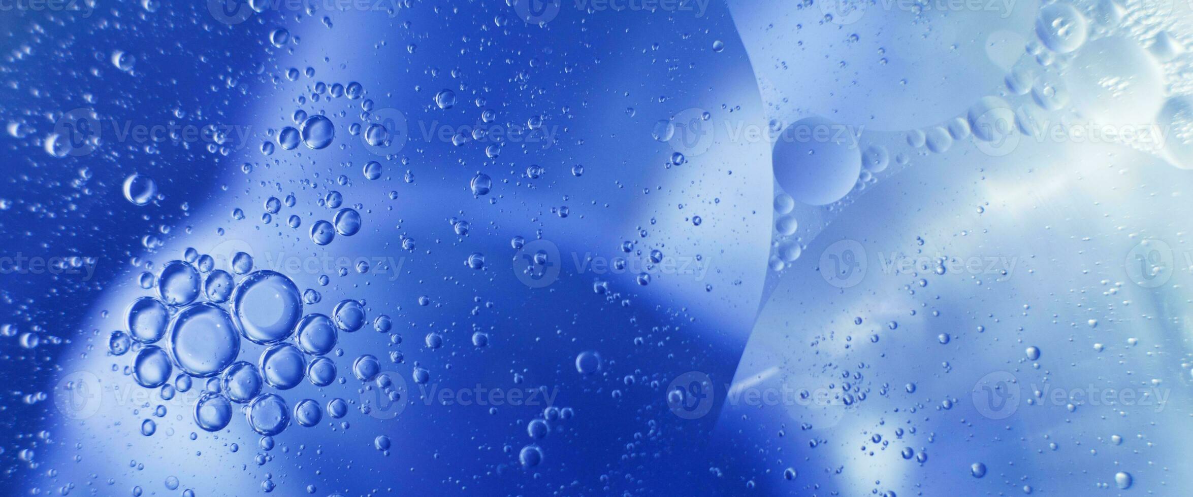 Oil bubbles close up. circles of water macro. abstract light blue background photo