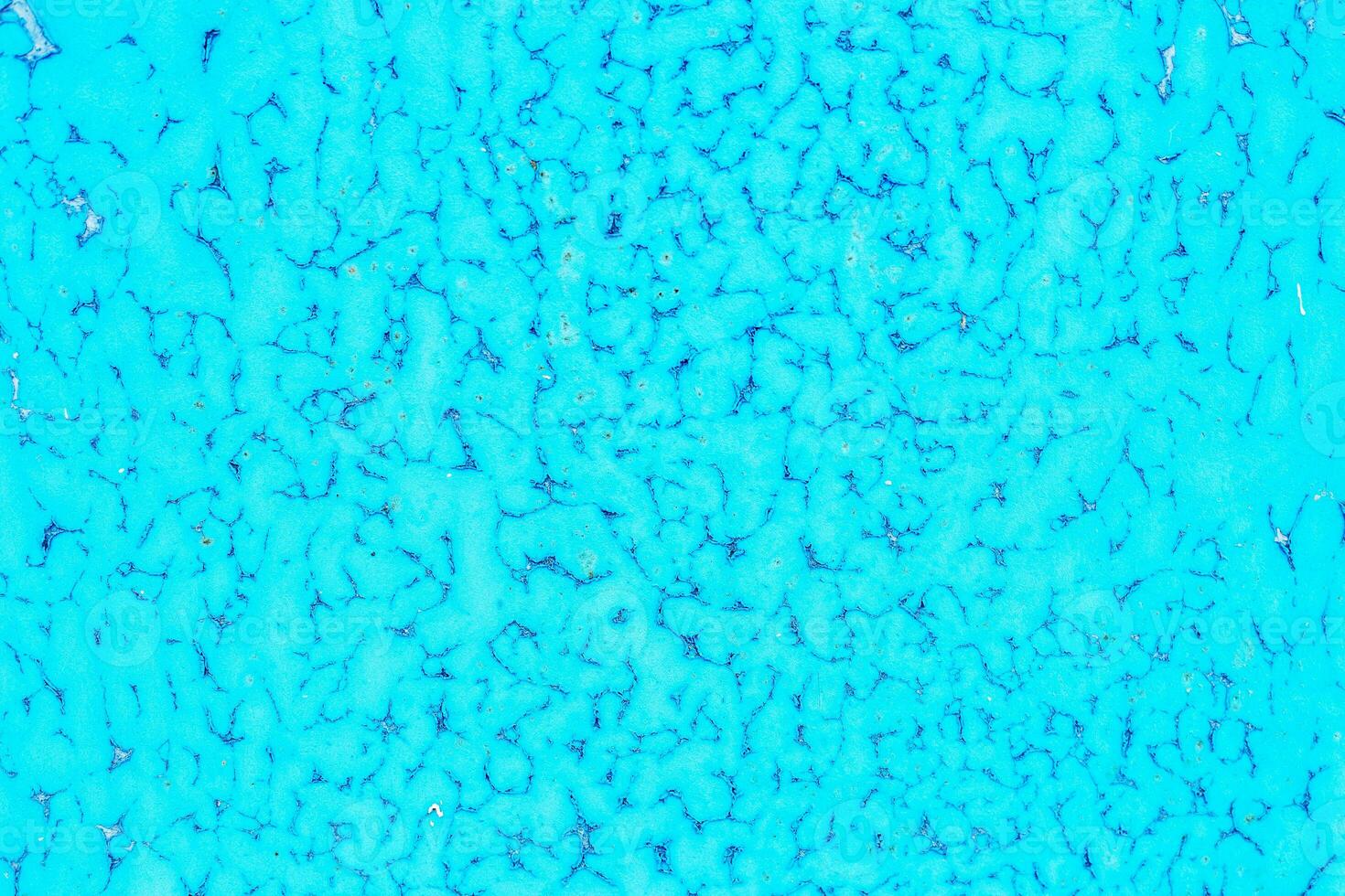 Old blue paint peeling from metal or concrete wall texture background. photo