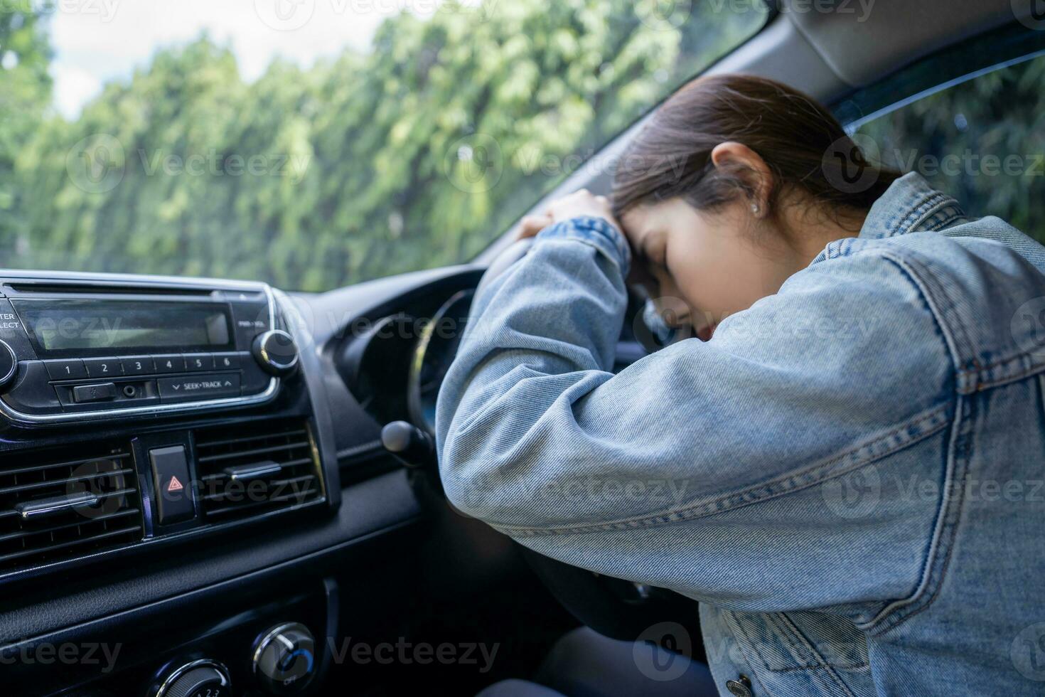 Sad Asian woman in the car, she is involved in a car accident photo