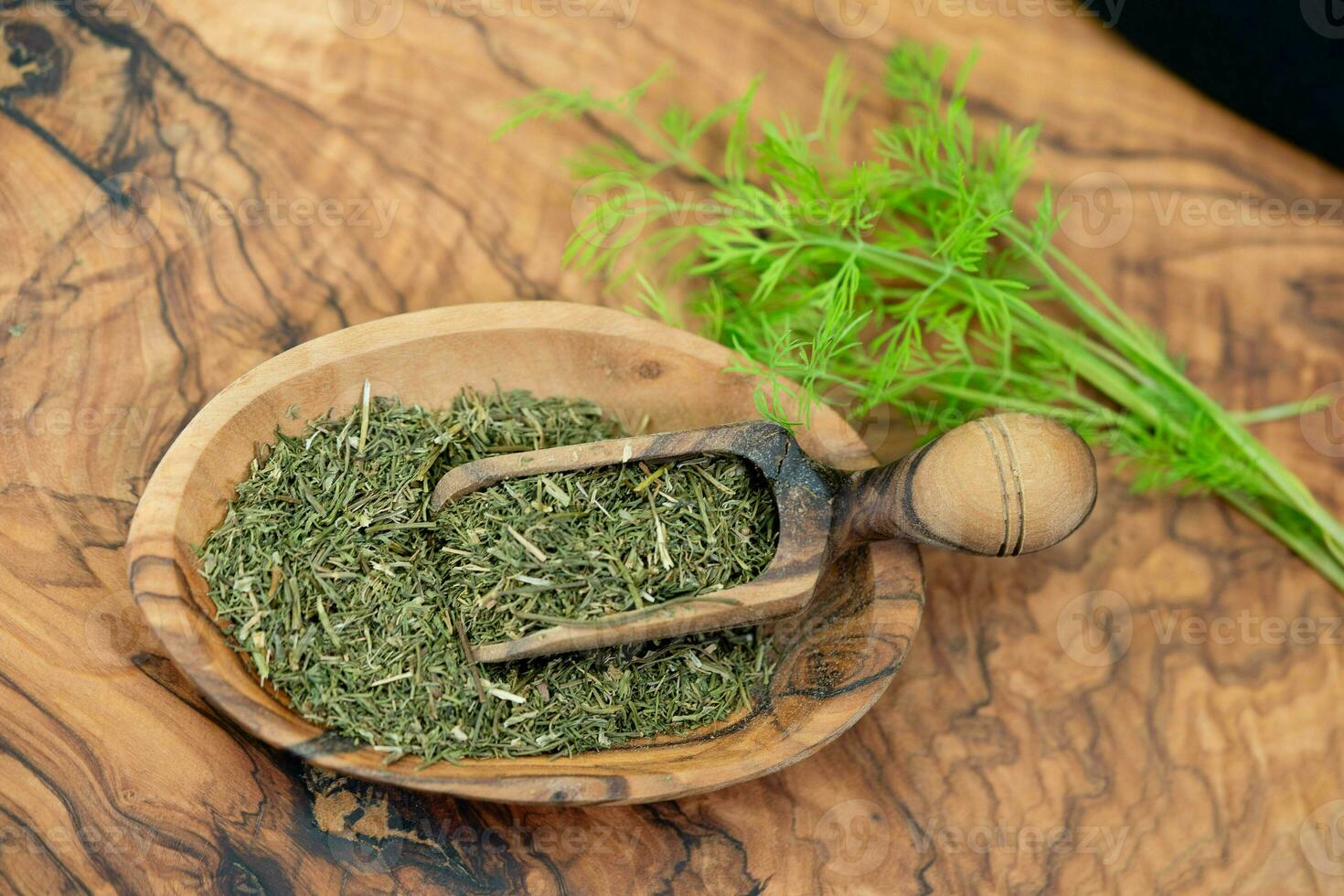Dill Anethum graveolens on olive wood photo