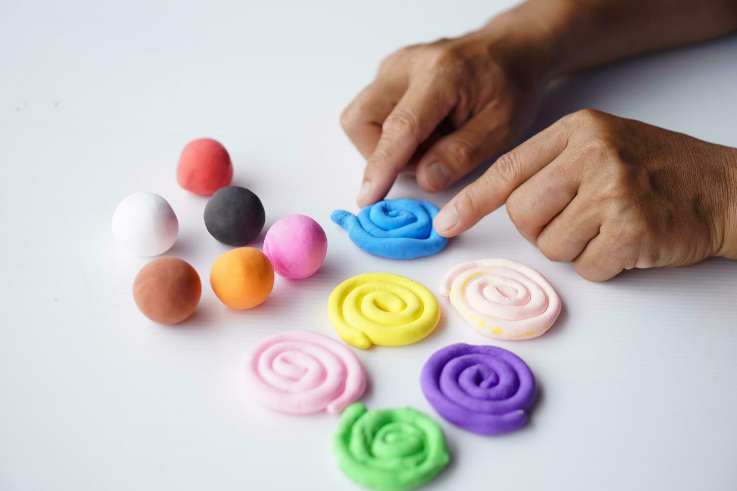 Close up hands sculpt plasticine into different shapes. Concept, alzheimer. weak muscle patients recovering activity by sculpting. Make concentration for ADHD or autistic symptom kids. Enhance imagine photo