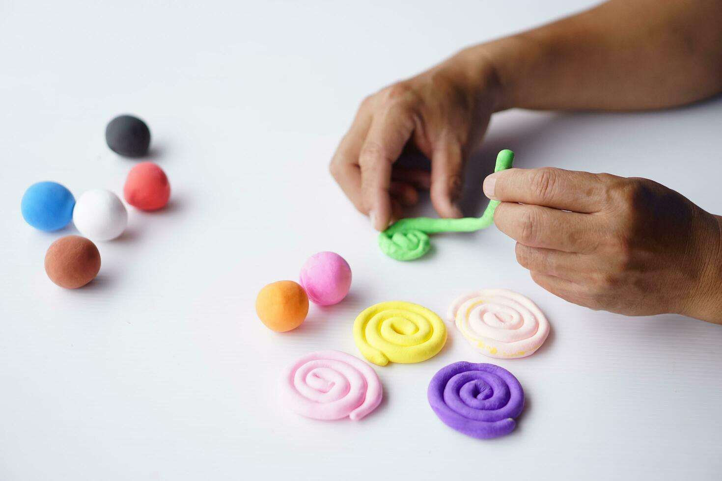 Close up hands sculpt plasticine into different shapes. Concept, alzheimer. weak muscle patients recovering activity by sculpting. Make concentration for ADHD or autistic symptom kids. Enhance imagine photo