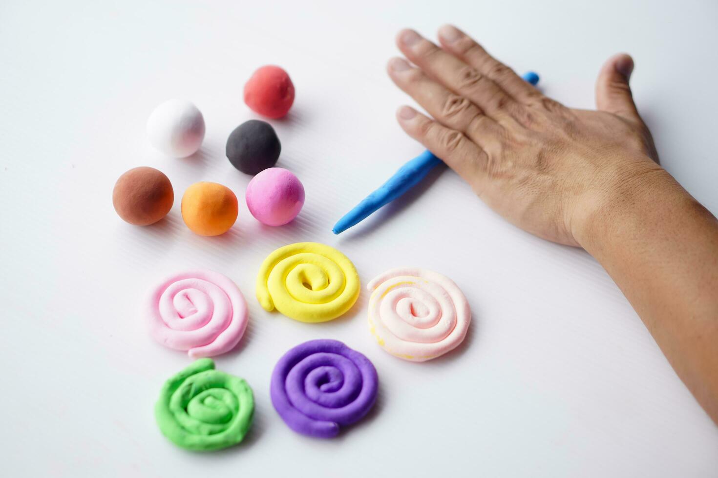 Close up hands sculpt plasticine into different shapes. Concept, alzheimer, weak muscle patients recovering activity by sculpting. Make concentration for ADHD or autistic symptom kids. Enhance imagine photo