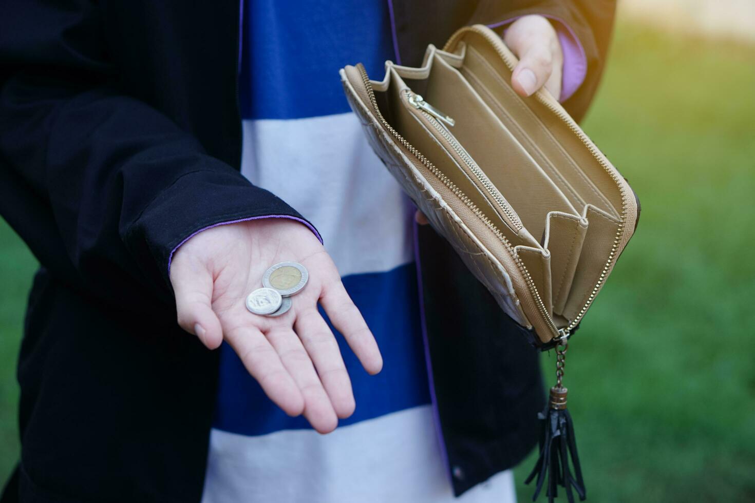 Close up hands holding empty wallet and shows Thai coins money. Concept, poor, bad economic crisis. Financial problems. Broke or less money at the end of month. photo