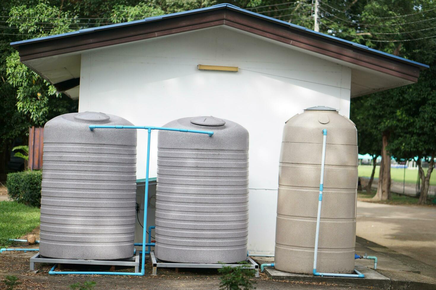 Big water tank installed outdoor for storage freshwater or rainwater to use in house or accommodation during summer or drought. Made of special grade material, extra thick, UV protection, no moss. photo