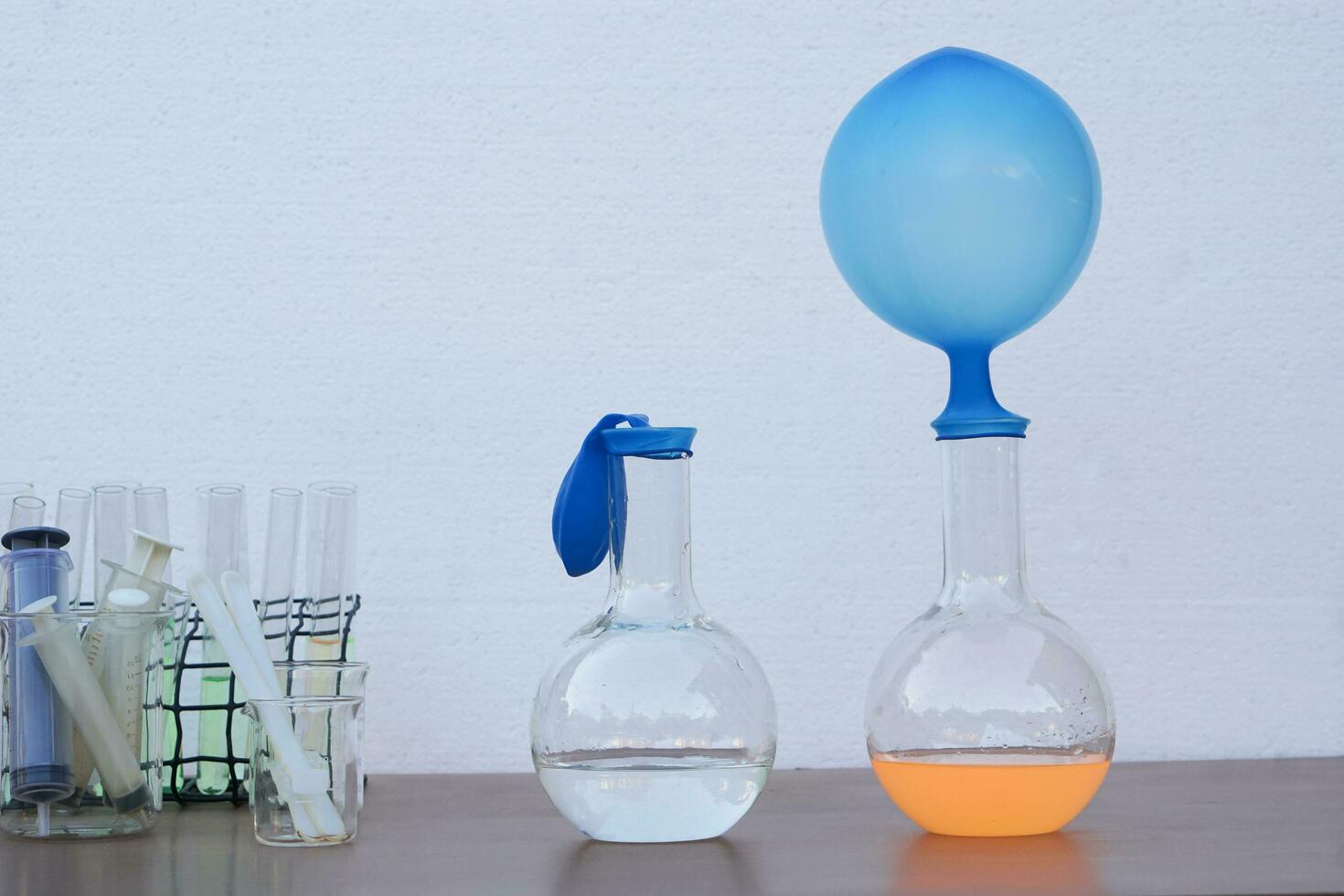 Blue balloons on top of test tubes. Concept, easy and fun Science experiment about the reaction of chemical in test bottles and balloons. Teaching materials, Education. photo