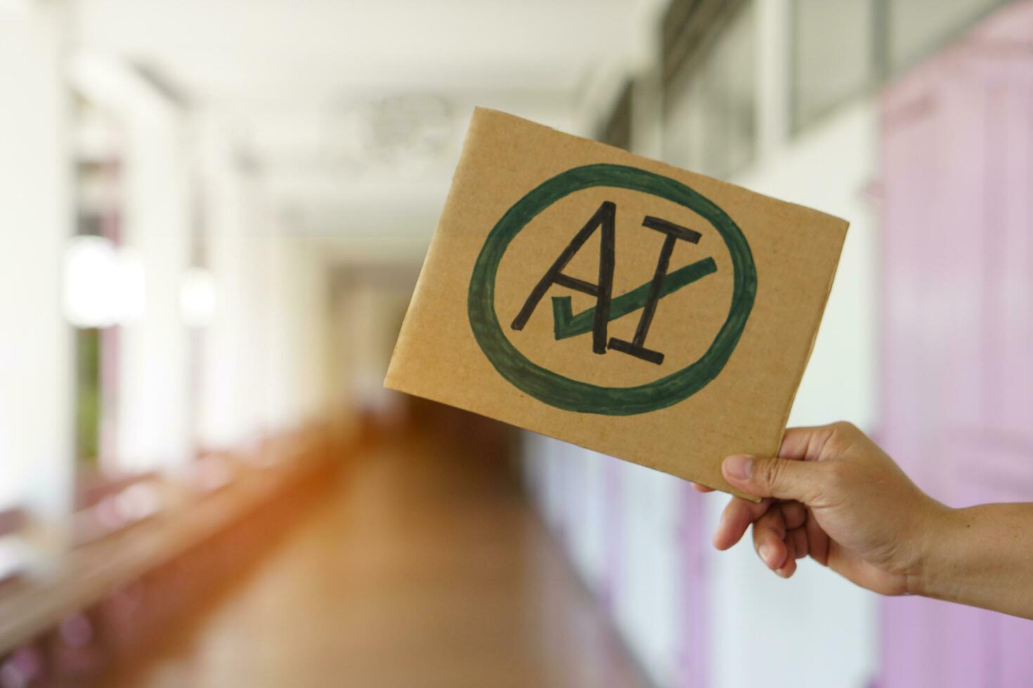 Close up hand holds paper card with  drawn sign AI in circle and tick mark. Concept, Choose ,agree and accept to use AI or Artificial Intelligence to apply in daily life. photo