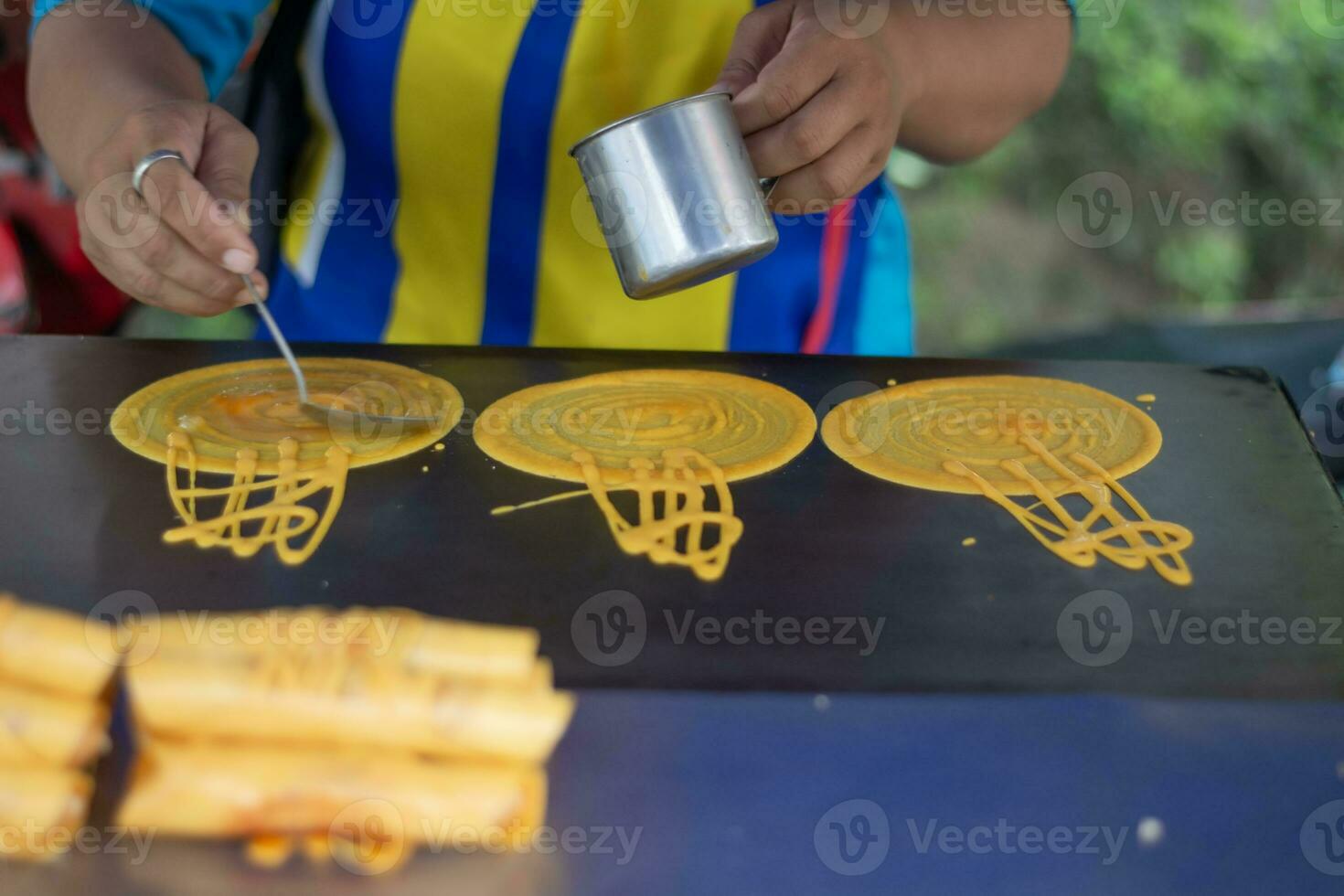 Steps for making Pancake Rolls Custard Outdoors Make several small pancakes at the same time. photo
