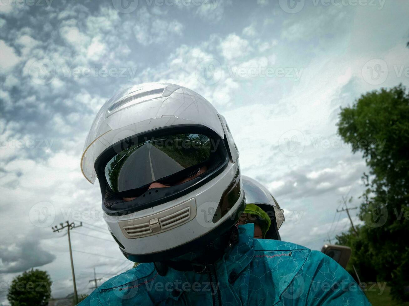 man wearing white helmet driving a motorcycle photo