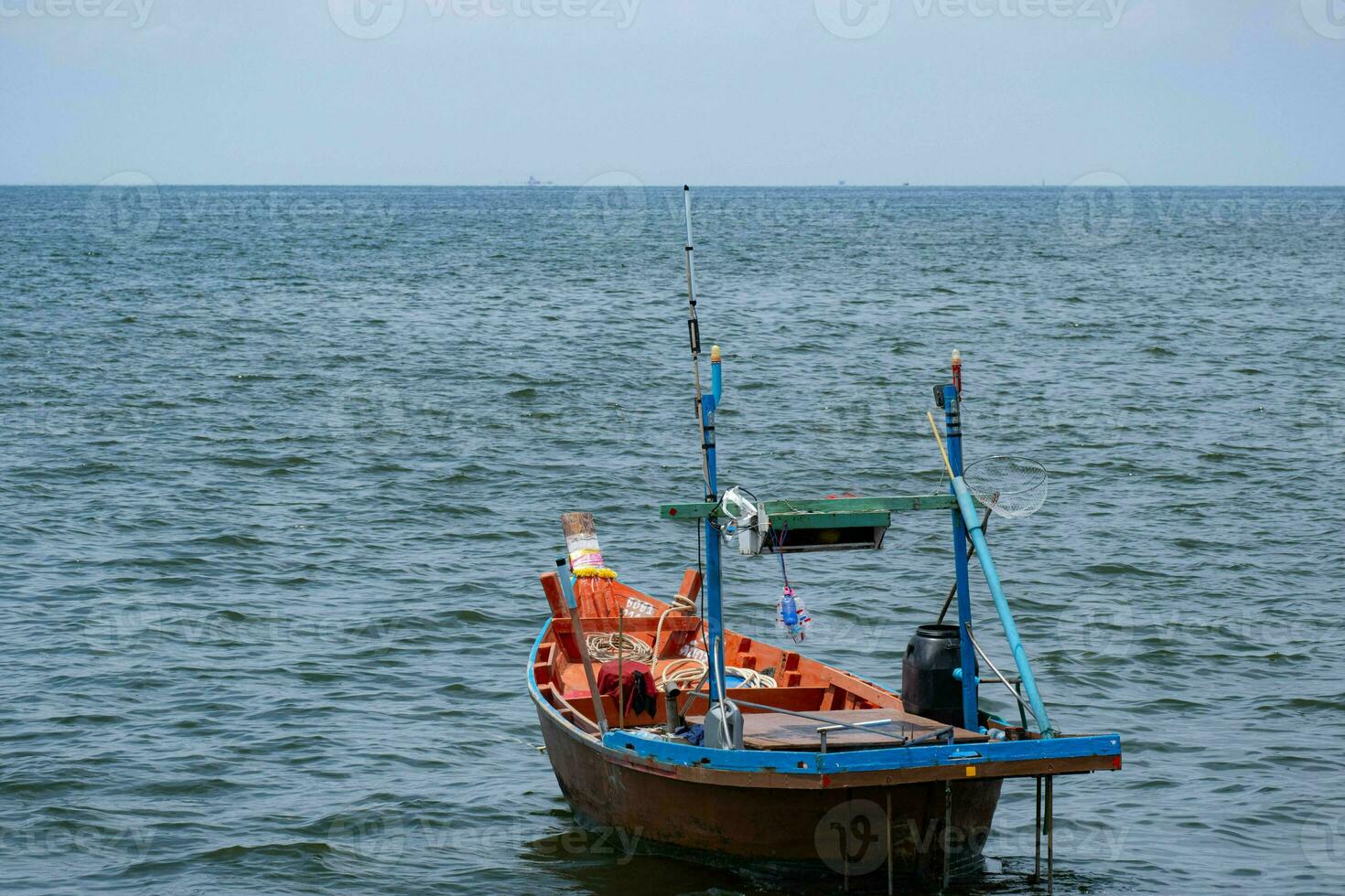 Fishing boats used to catch fish Located on sea water with slight waves. Used to find food for people who earn a living catching fish. For those who live next to the sea photo