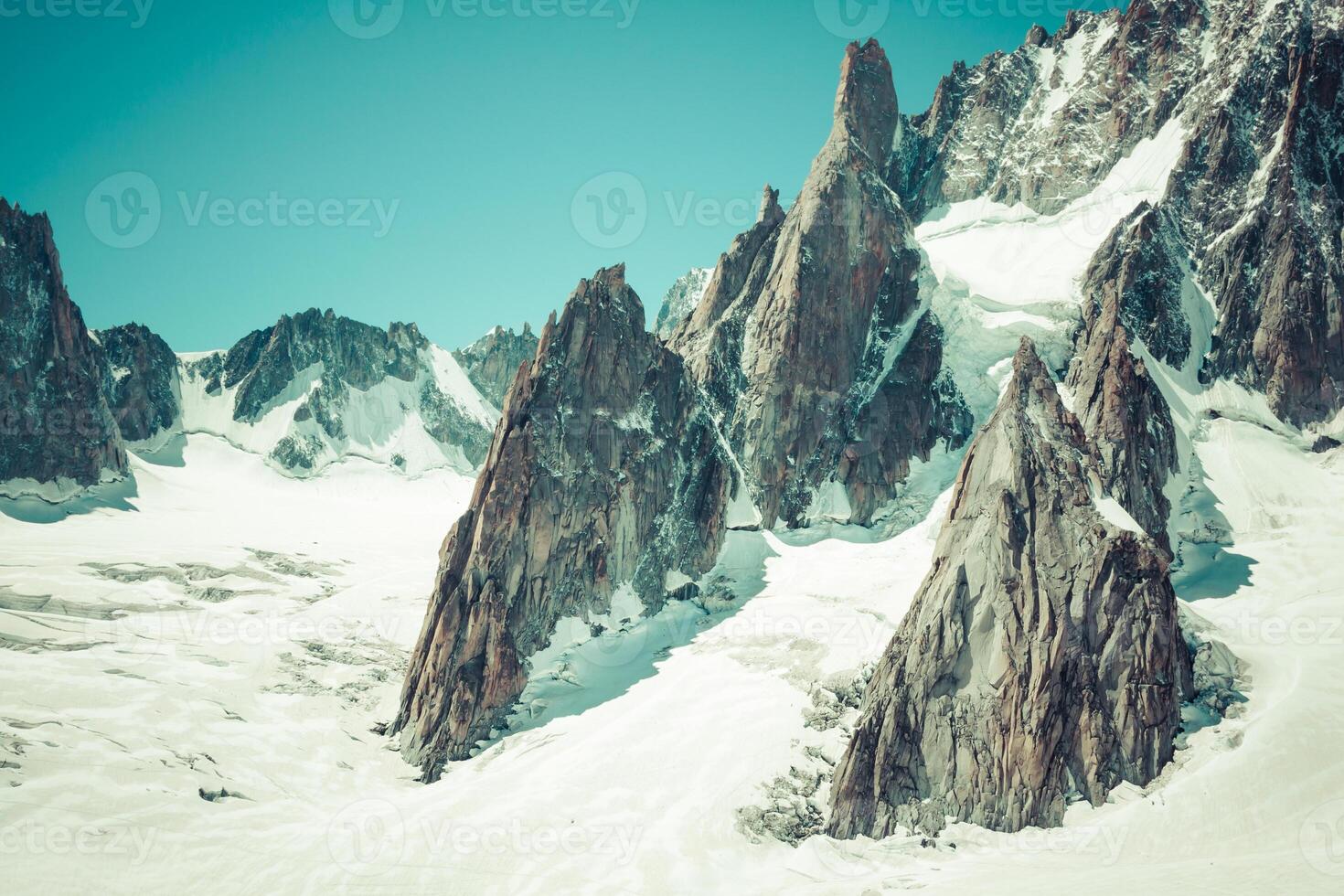 Massif de mont Blanc on the border of France and Italy. In the foreground the ice field and crevasses of the Valley Blanche photo