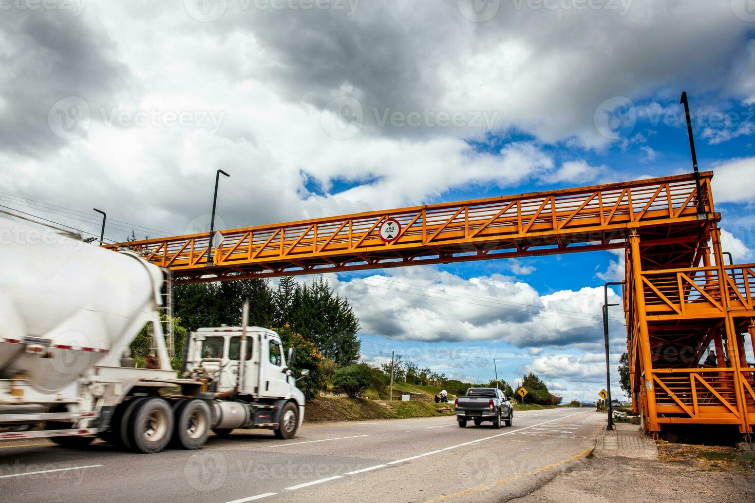 Pedestrian bridge over a high-speed road with heavy traffic. Road safety concept. photo