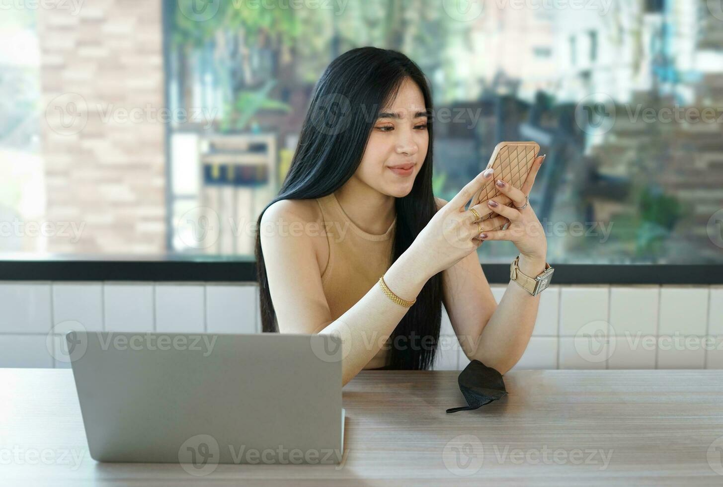 attractive business woman in suit sitting at counter bar, young modern female remote work, a digital nomad working over laptop internet online in cafe indoors photo