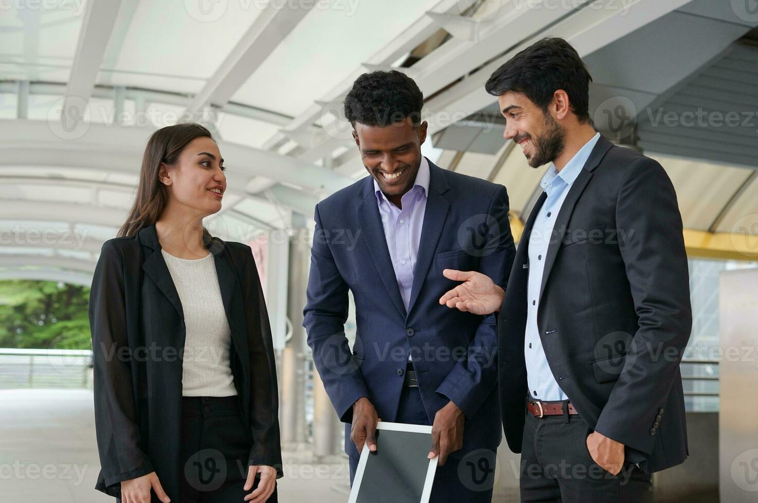 multiracial business people chatting happily during break while work outside, concept good working relationship, good relationship at work photo