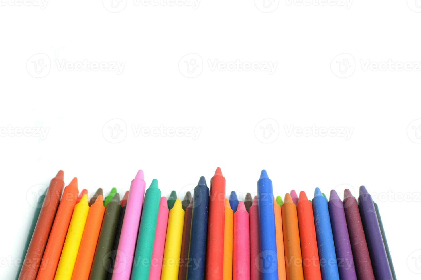 Crayons lined up isolated on white background. photo