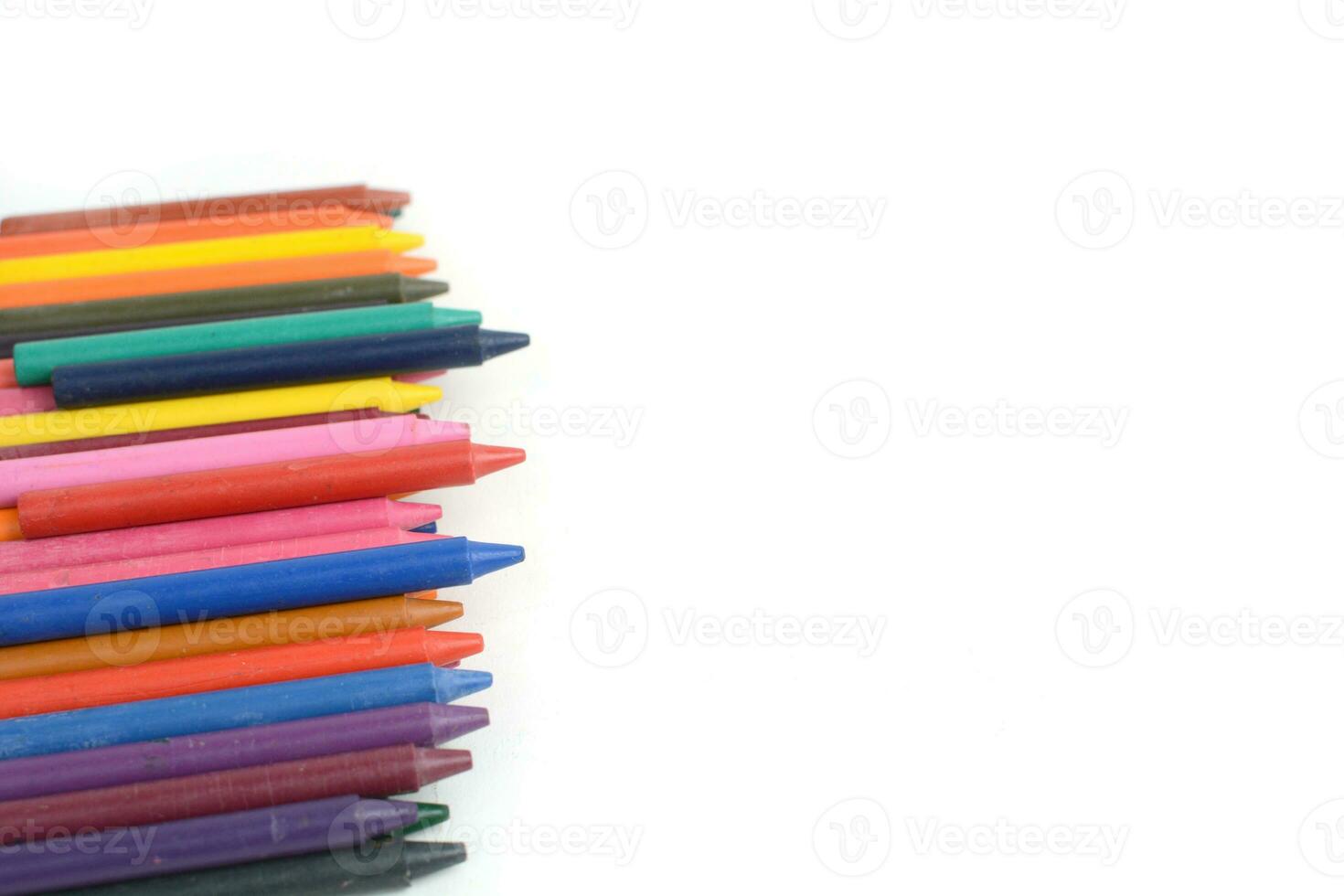 Crayons lined up isolated on white background. photo