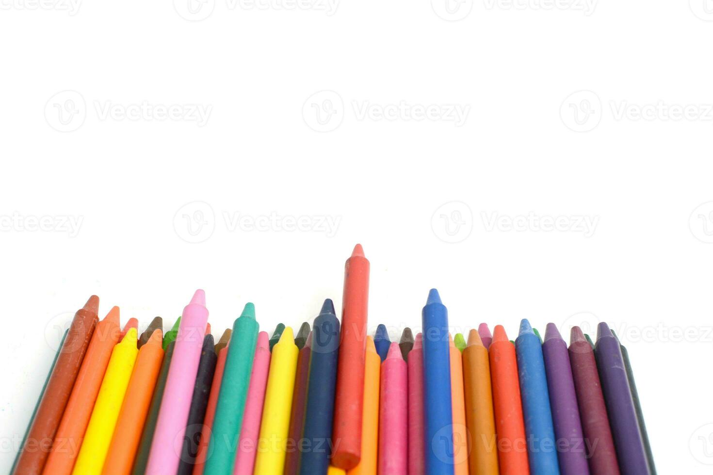 Crayons lined up isolated on white background. photo