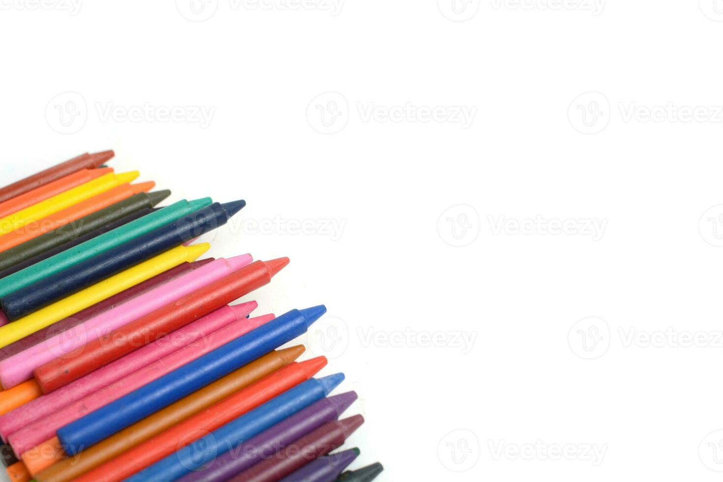 Crayons lined up isolated on white background. photo