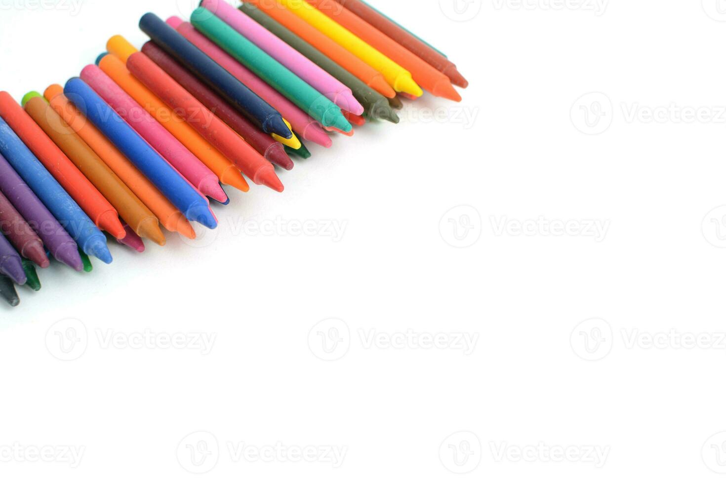 Crayons lined up isolated on white background. photo