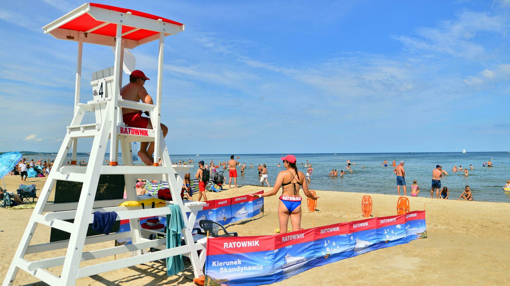 Swinoujscie, Poland. 15 August 2023. Lifeguards with rescue tower on the beach of the Baltic Sea photo