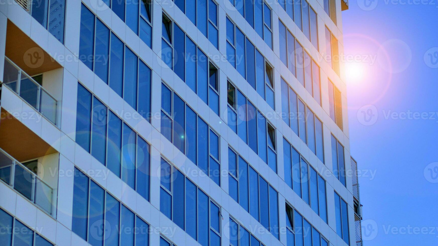 Exterior of a high modern multi-story apartment building - facade, windows and balconies. photo