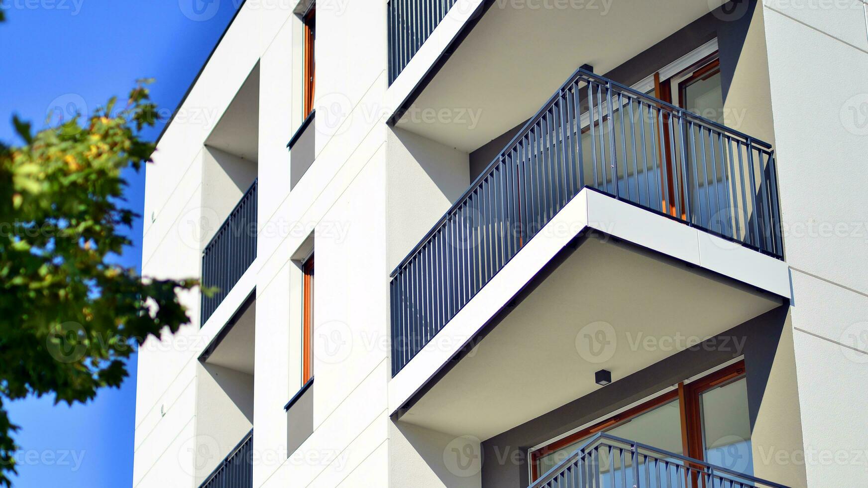 Green community. Eco apartment building saving energy and fresh air concept. Block of flats in beautiful green public photo