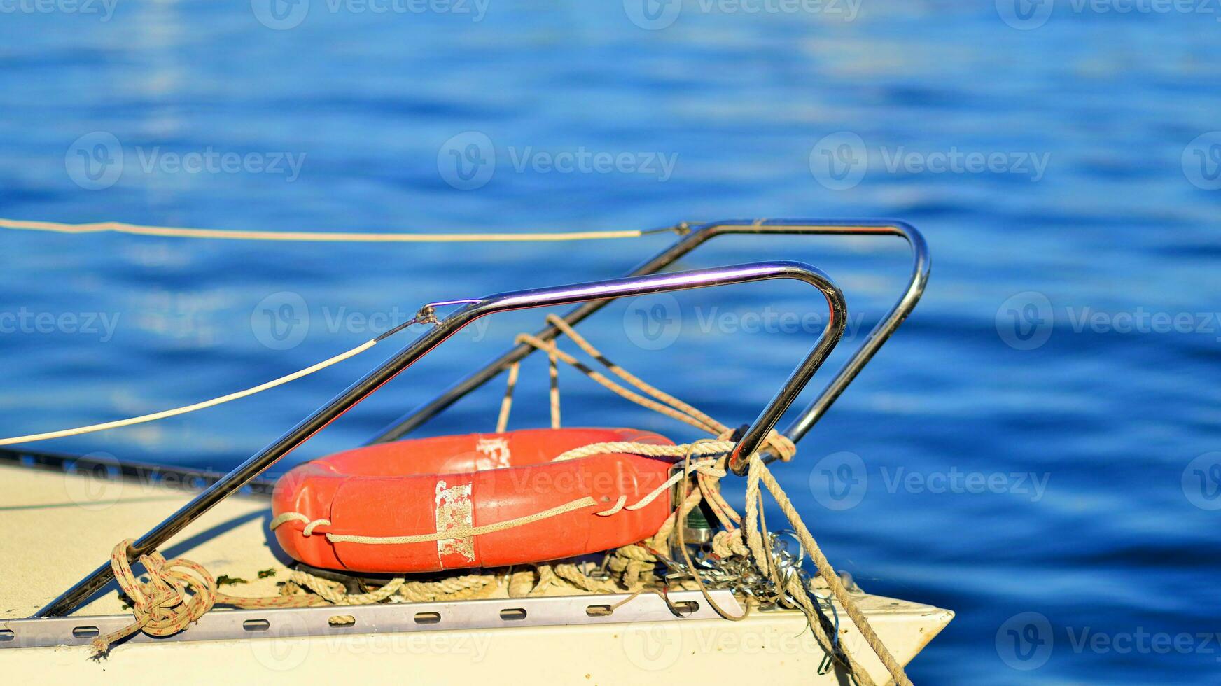 View of the front of a boat with an orange lifebuoy photo