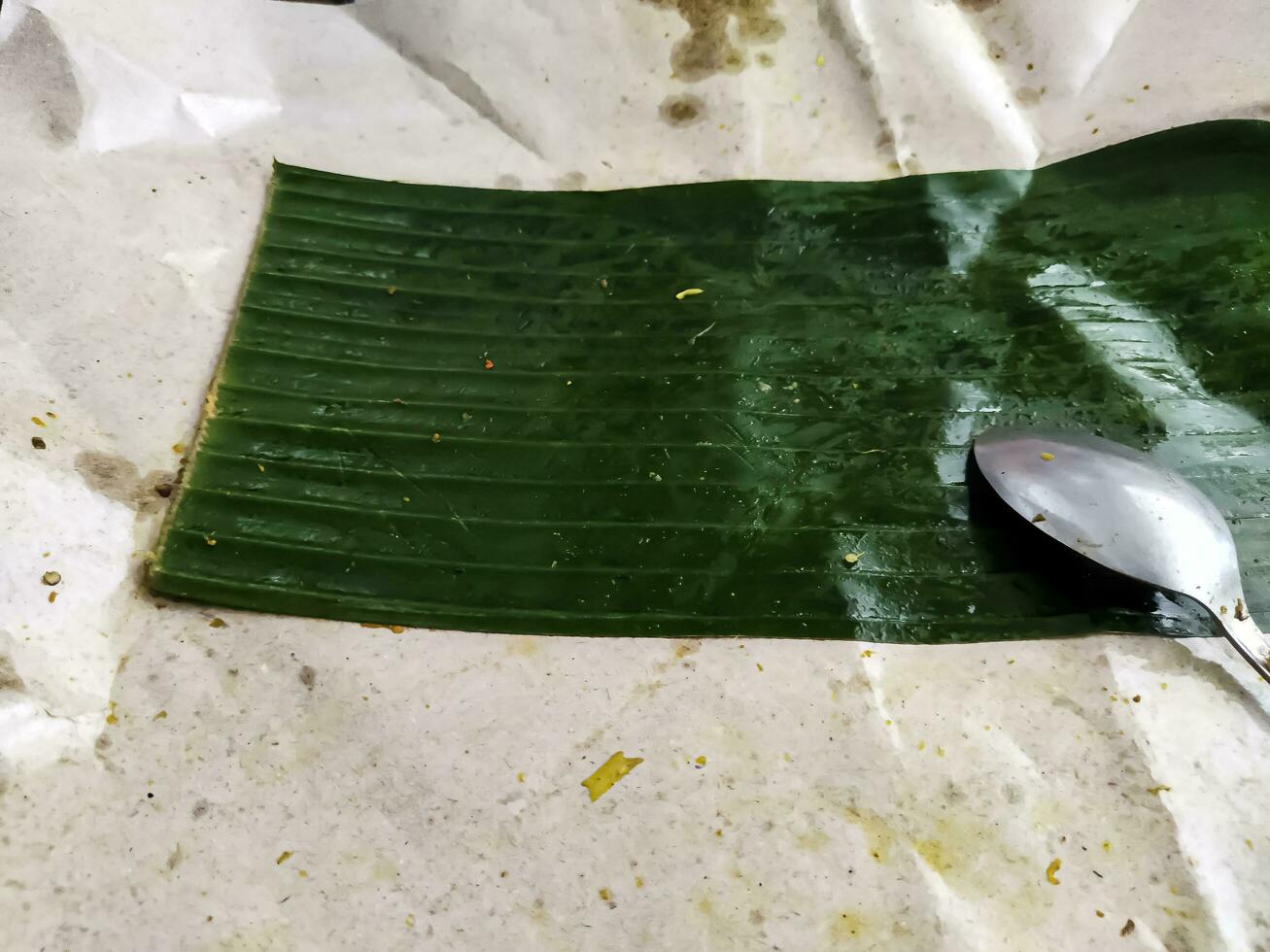 Spoon over dirty leaves used to wrap rice photo