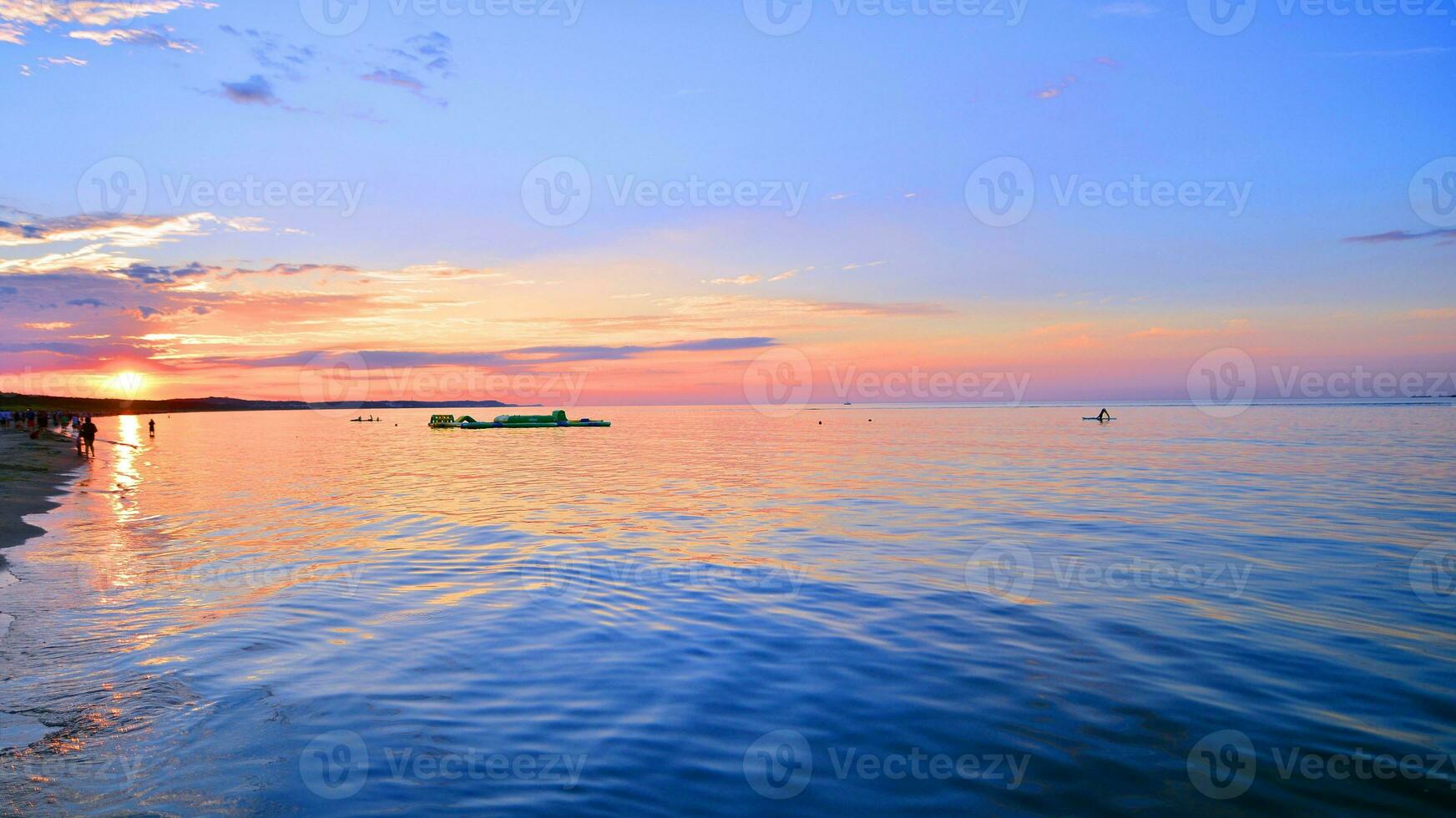 A summer sunset scenery on the horizon. Sea in golden colors and amazing clouds on sky. photo