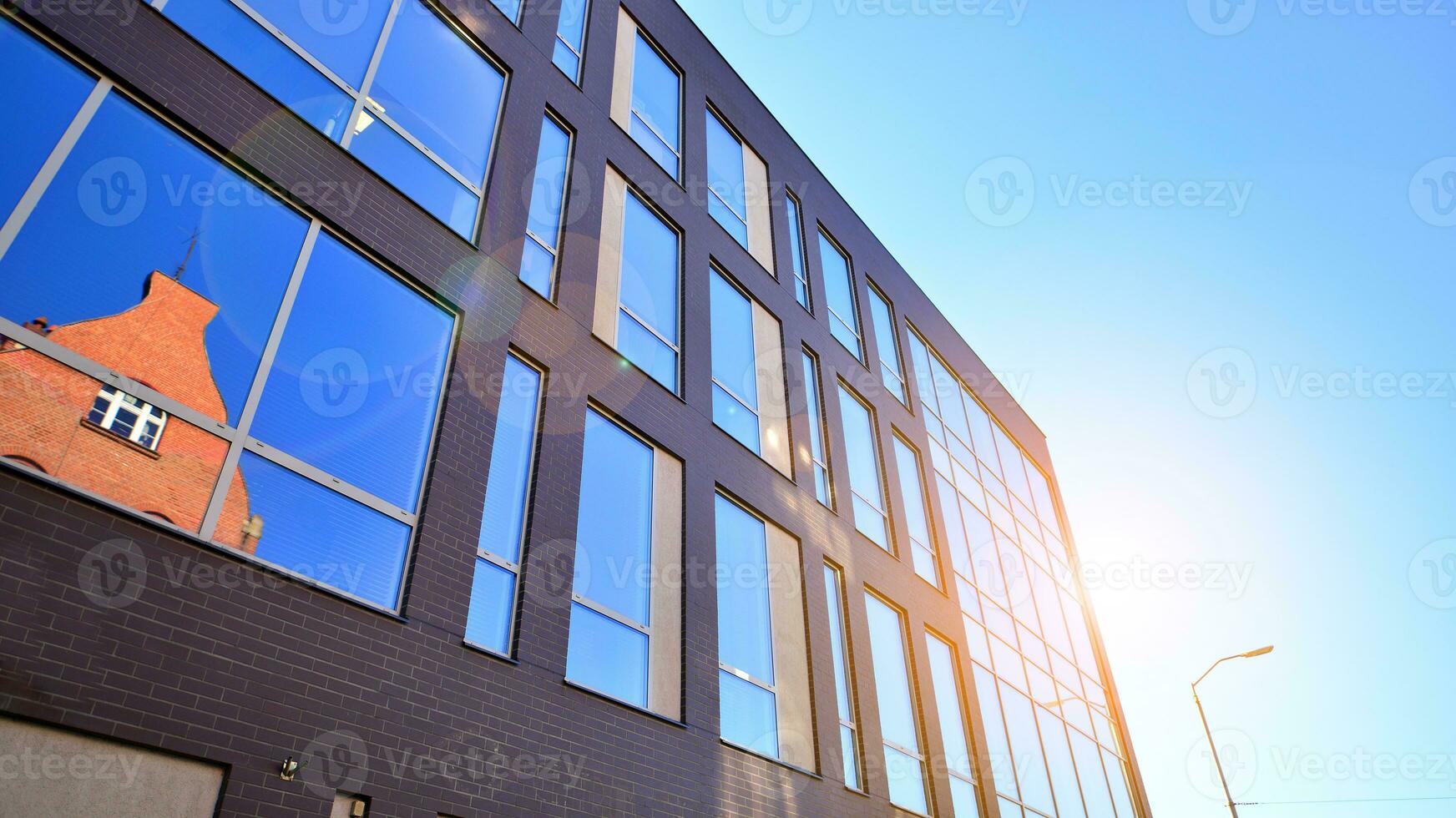 Architecture details. Modern glass building facade in sunny day. Business background. photo