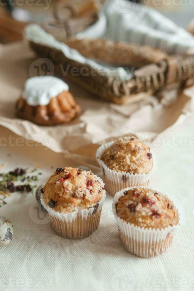 Easter cupcakes with raisins and quail eggs on a white table close-up. The concept of celebrating Happy Easter. photo