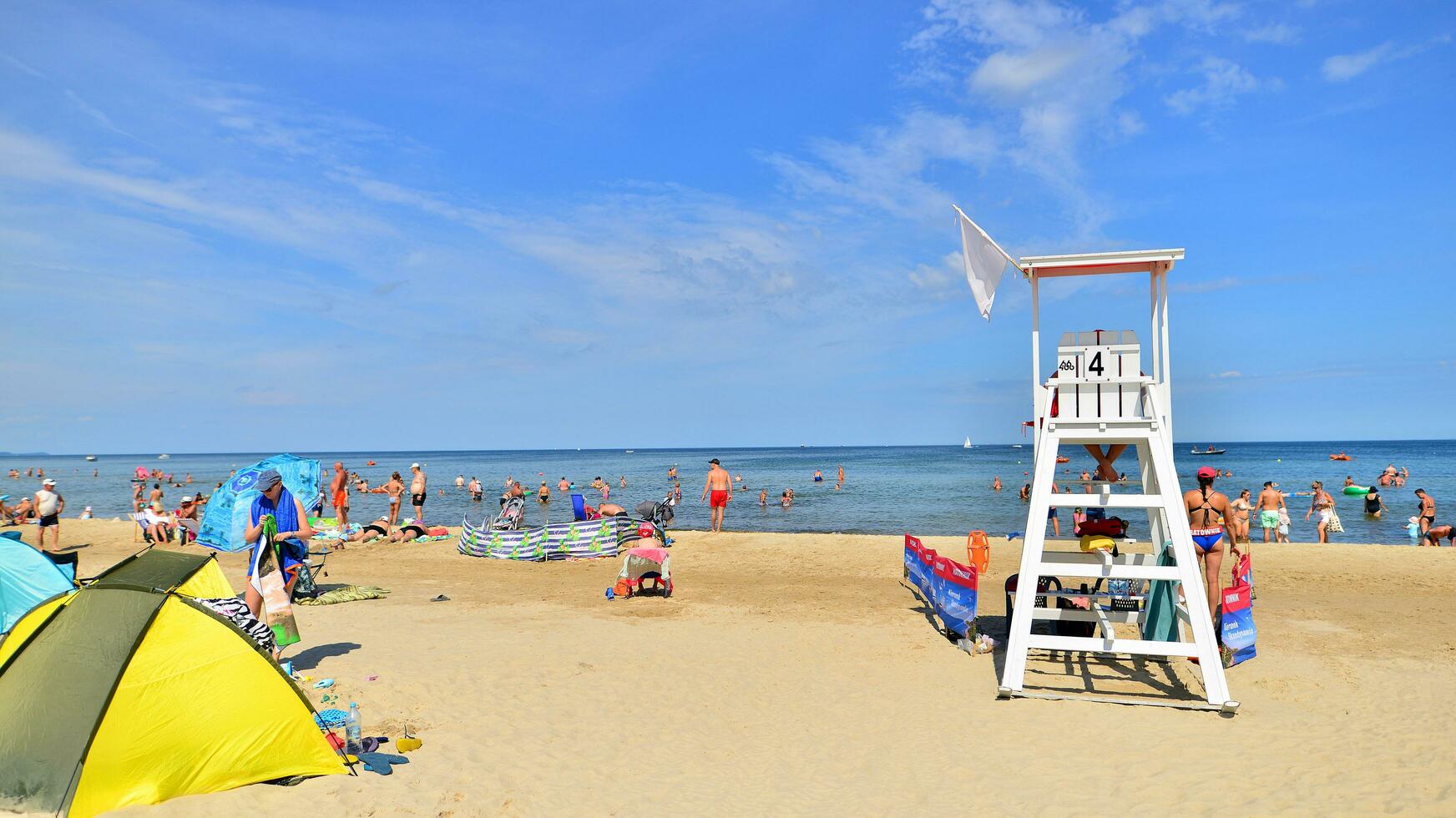 Swinoujscie, Poland. 15 August 2023. Lifeguards with rescue tower on the beach of the Baltic Sea photo