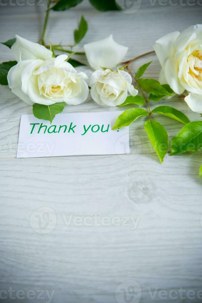 beautiful white summer roses, on a wooden table photo