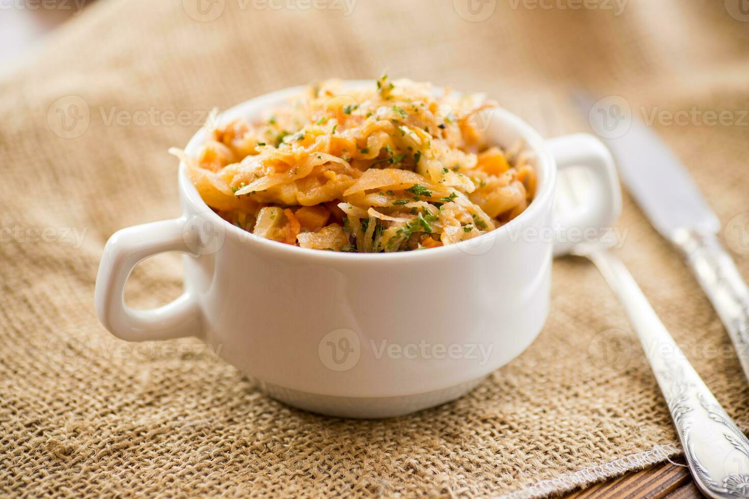stewed cabbage with carrots and spices in a bowl photo
