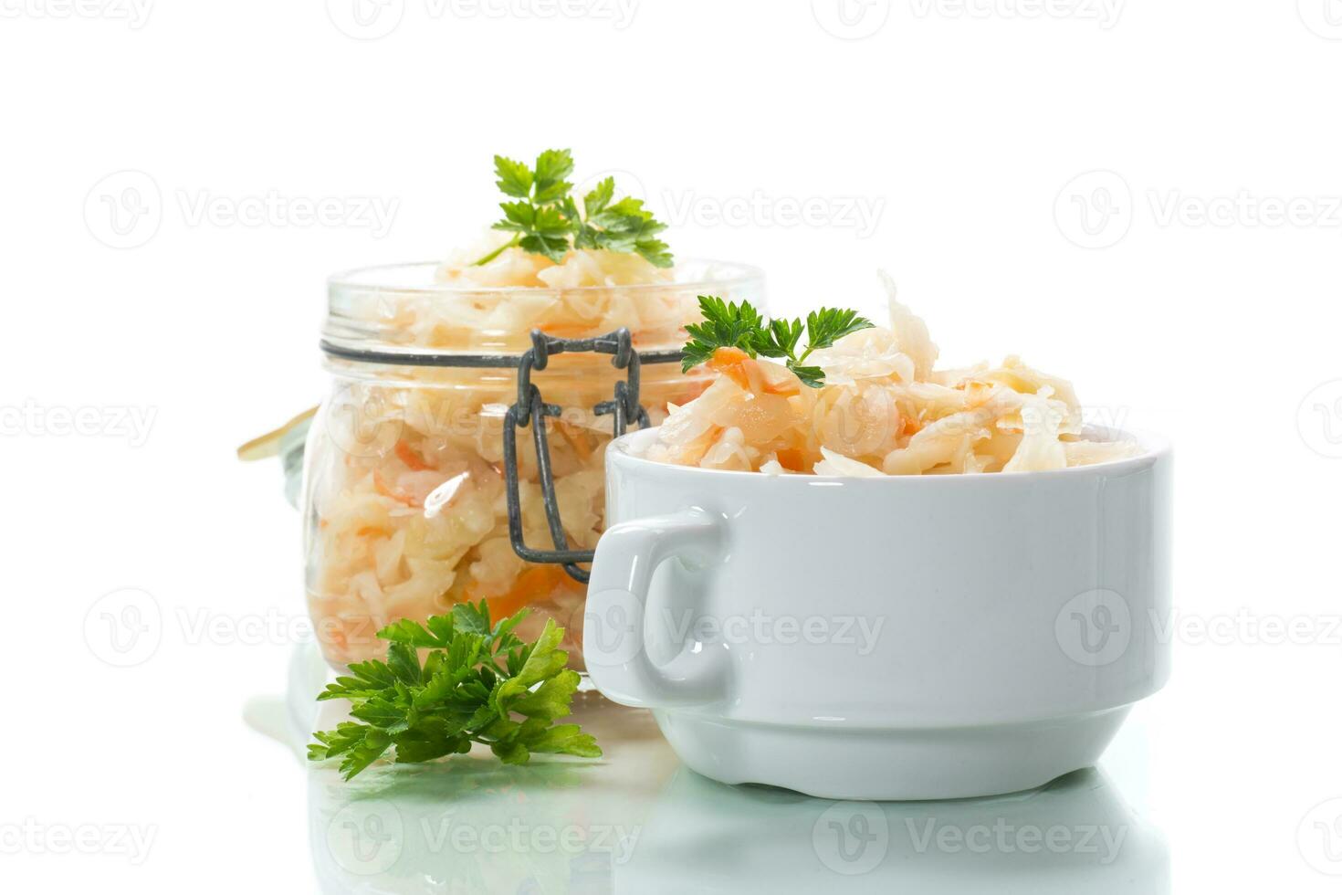Sauerkraut with carrots and spices in a glass jar photo