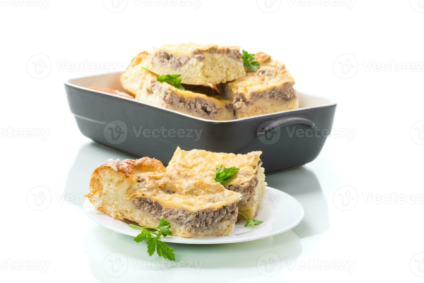 Cooked meat pie, pieces in a plate photo