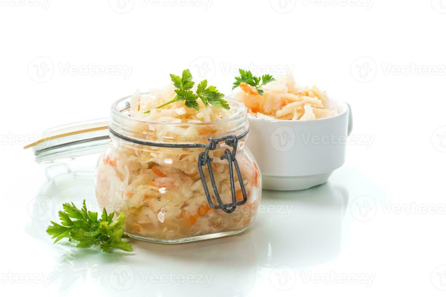 Sauerkraut with carrots and spices in a glass jar photo