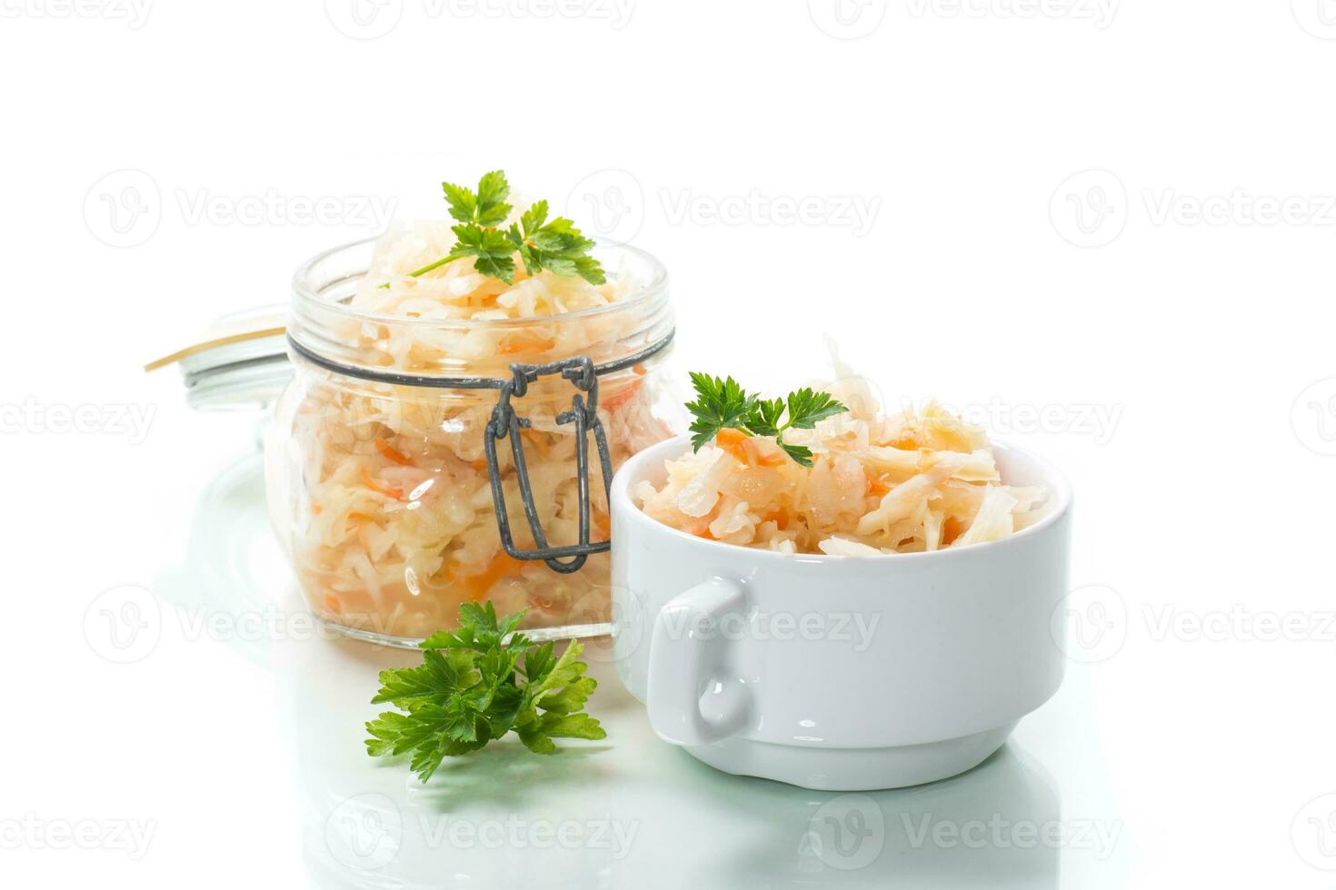 Sauerkraut with carrots and spices in a glass jar photo