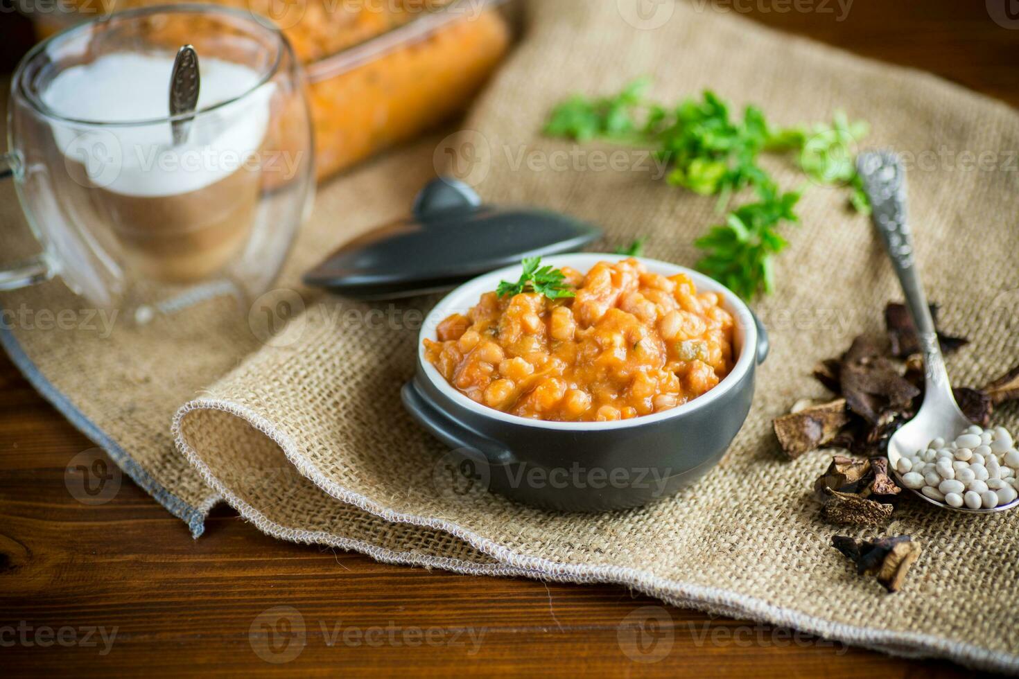beans stewed with vegetables and spices, in a bowl . photo