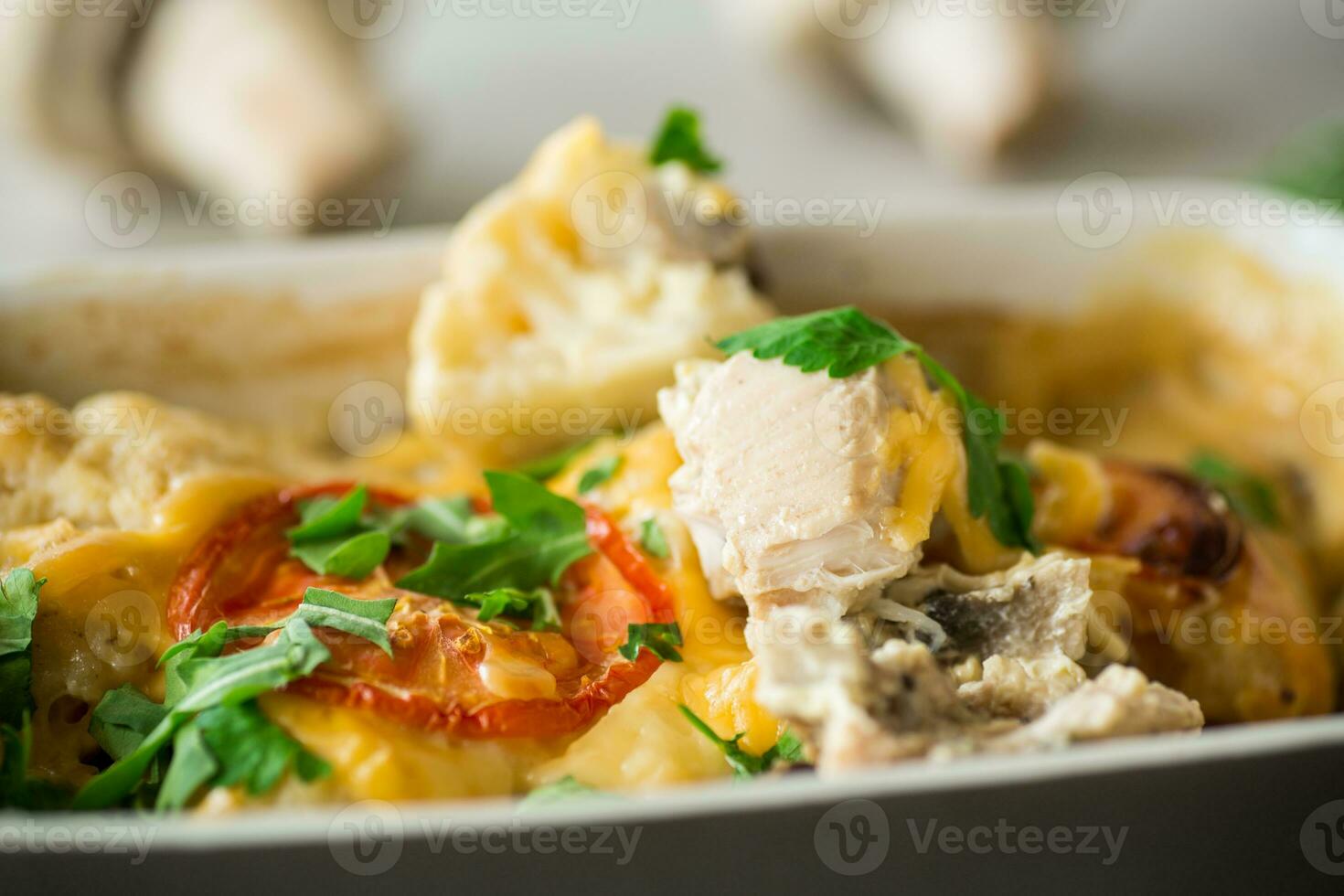 cauliflower baked with chicken fillet and mushrooms under cheese in a ceramic form photo