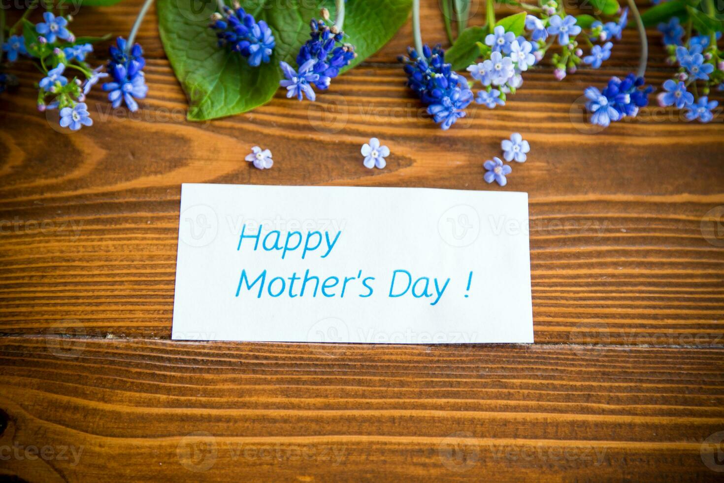 Wooden background with spring flowers and empty space photo