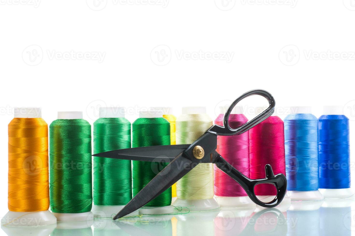 set of different color sewing threads,on white background. photo