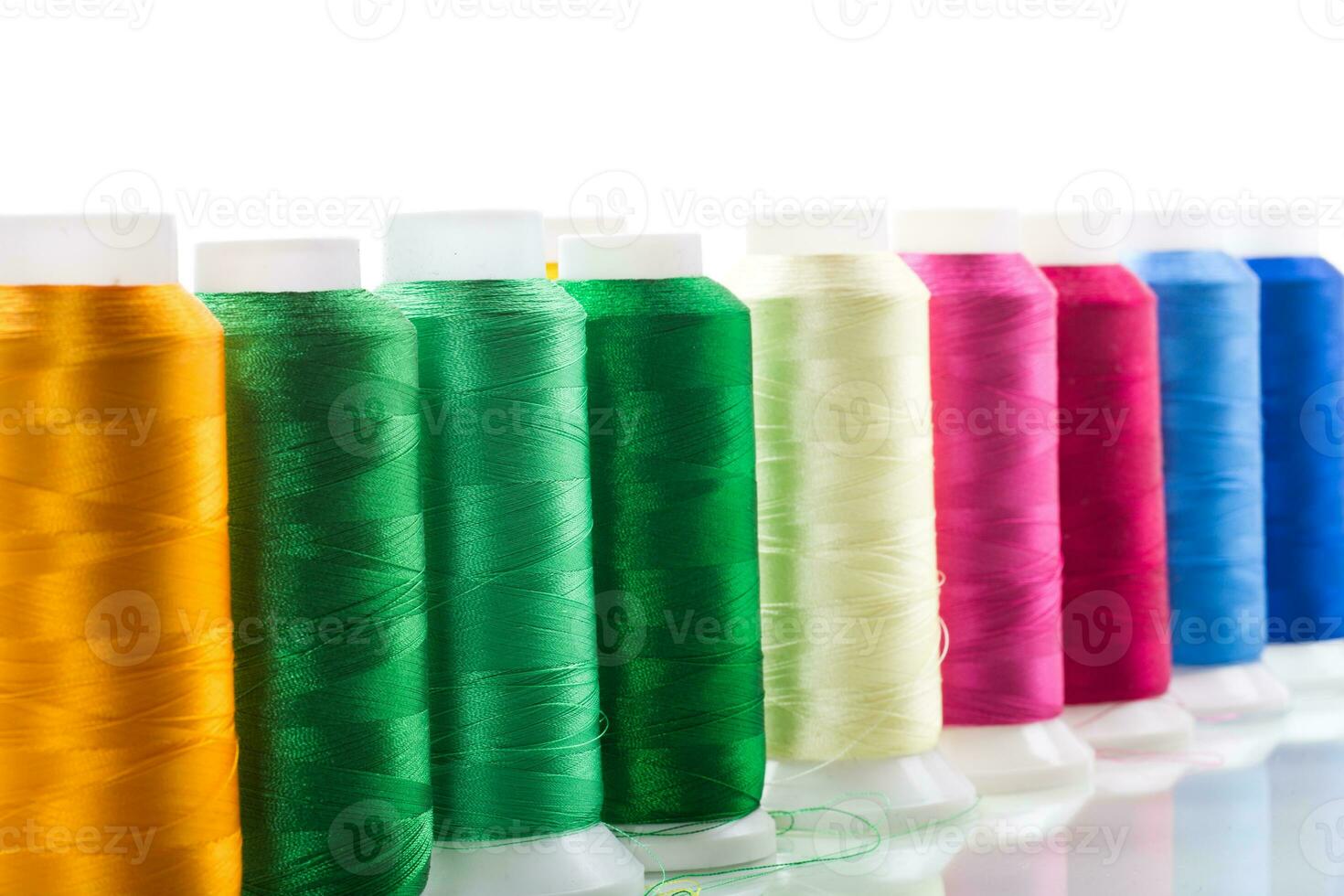 set of different color sewing threads,on white background. photo