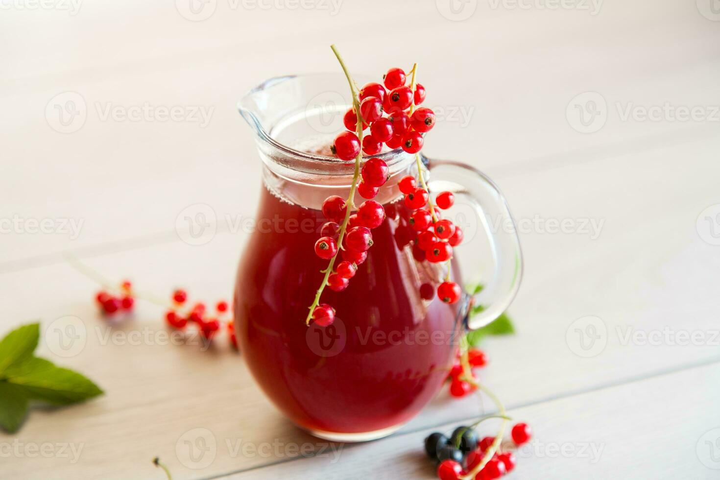 fresh berry juice from red and black currant, on a wooden table photo