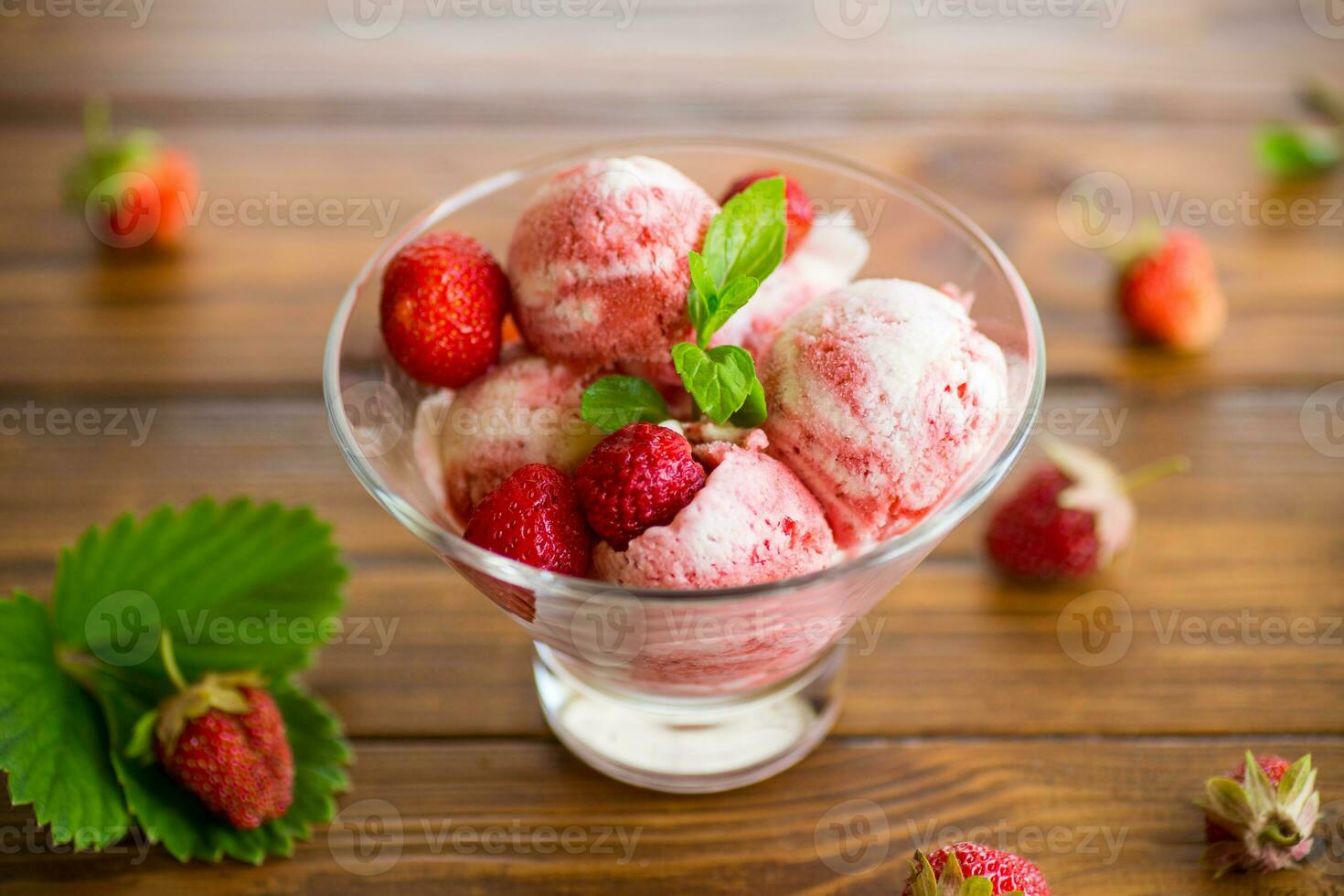 Balls of homemade strawberry ice cream in a bowl photo