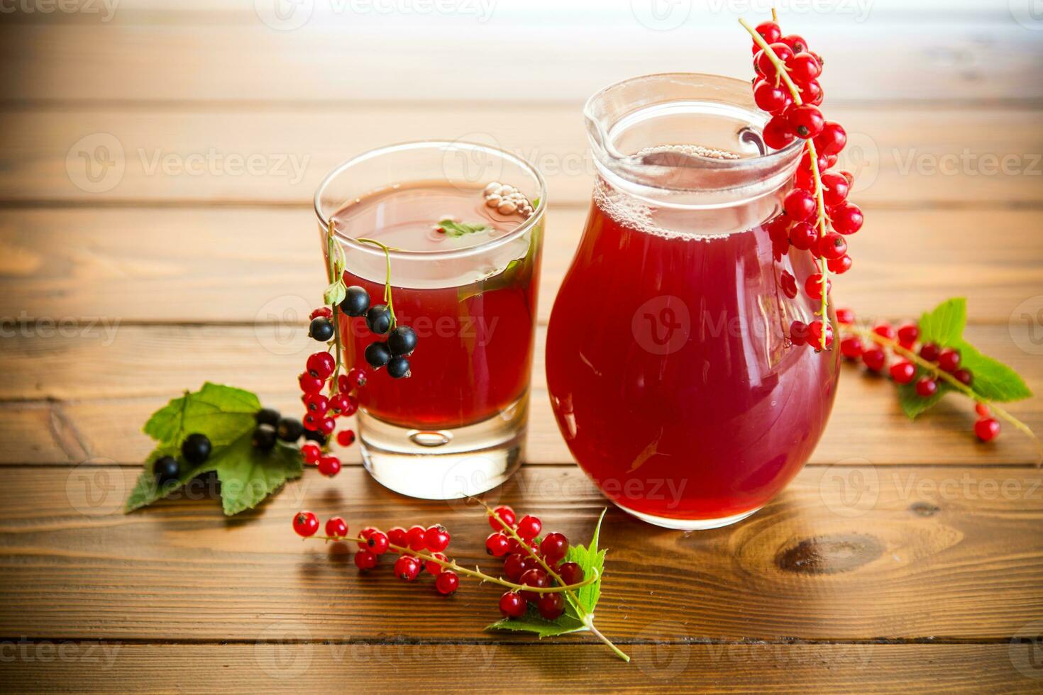 fresh berry juice from red and black currant, on a wooden table photo