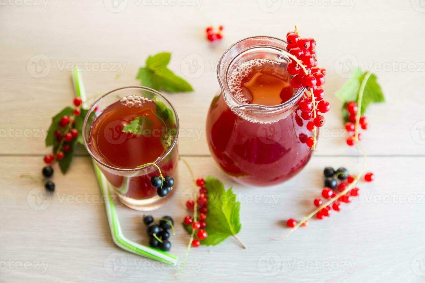 fresh berry juice from red and black currant, on a wooden table photo